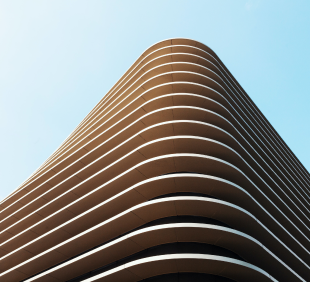 Modern white building with curved balconies